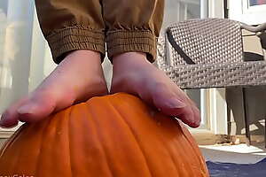 Boy bare feet smashes pumpkin plus plays with it